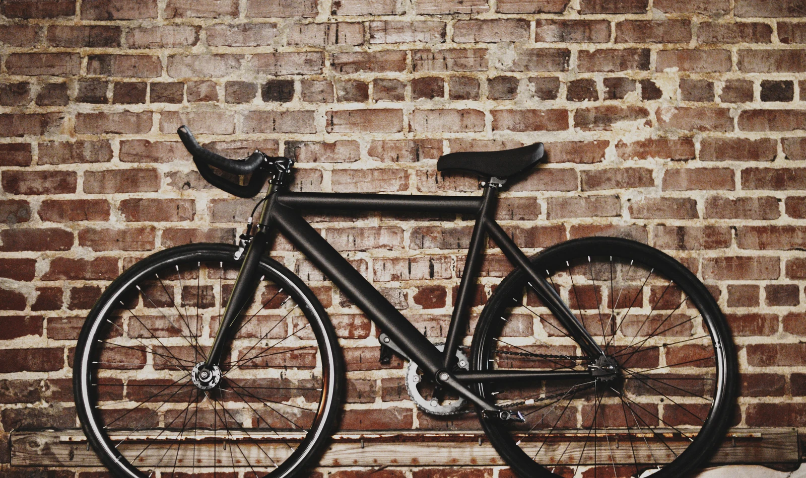 Patrol-style bicycle leaning against a brick wall